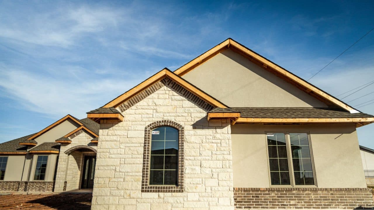 Home exterior with unfinished wood visible along the roof edges