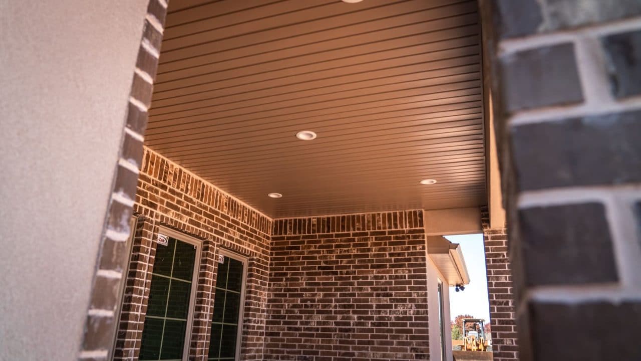 Finished soffit panels and recessed lights over a covered patio